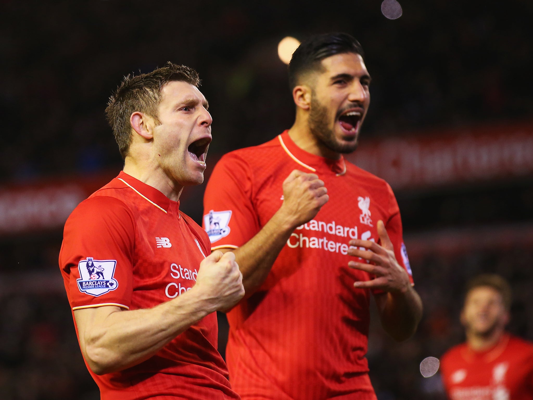 Jame Milner celebrates scoring in front of the Kop with teammate Emre Can