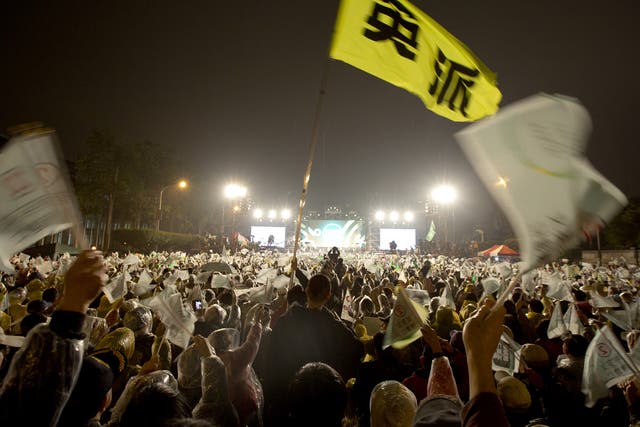 A flag with "Ing Clique" sign on flies in the sky during a rally in Taipei, Taiwan. Tsai Ing-wen, leader of the Democratic Progressive Party, leads in most polls ahead of Saturday's election in the island of 23 million people.