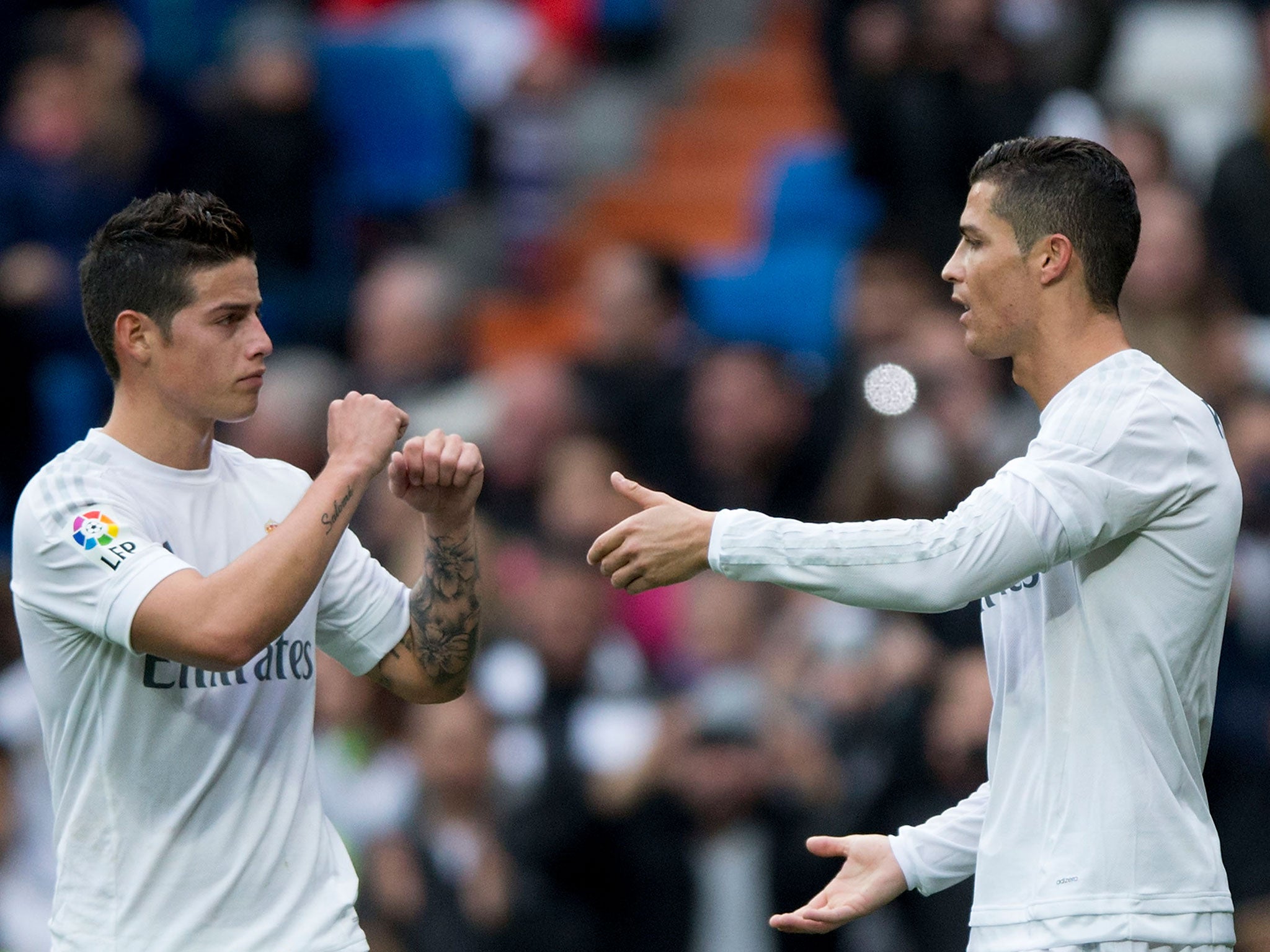 Real Madrid midfielder James Rodriguez celebrates with forward Cristiano Ronaldo