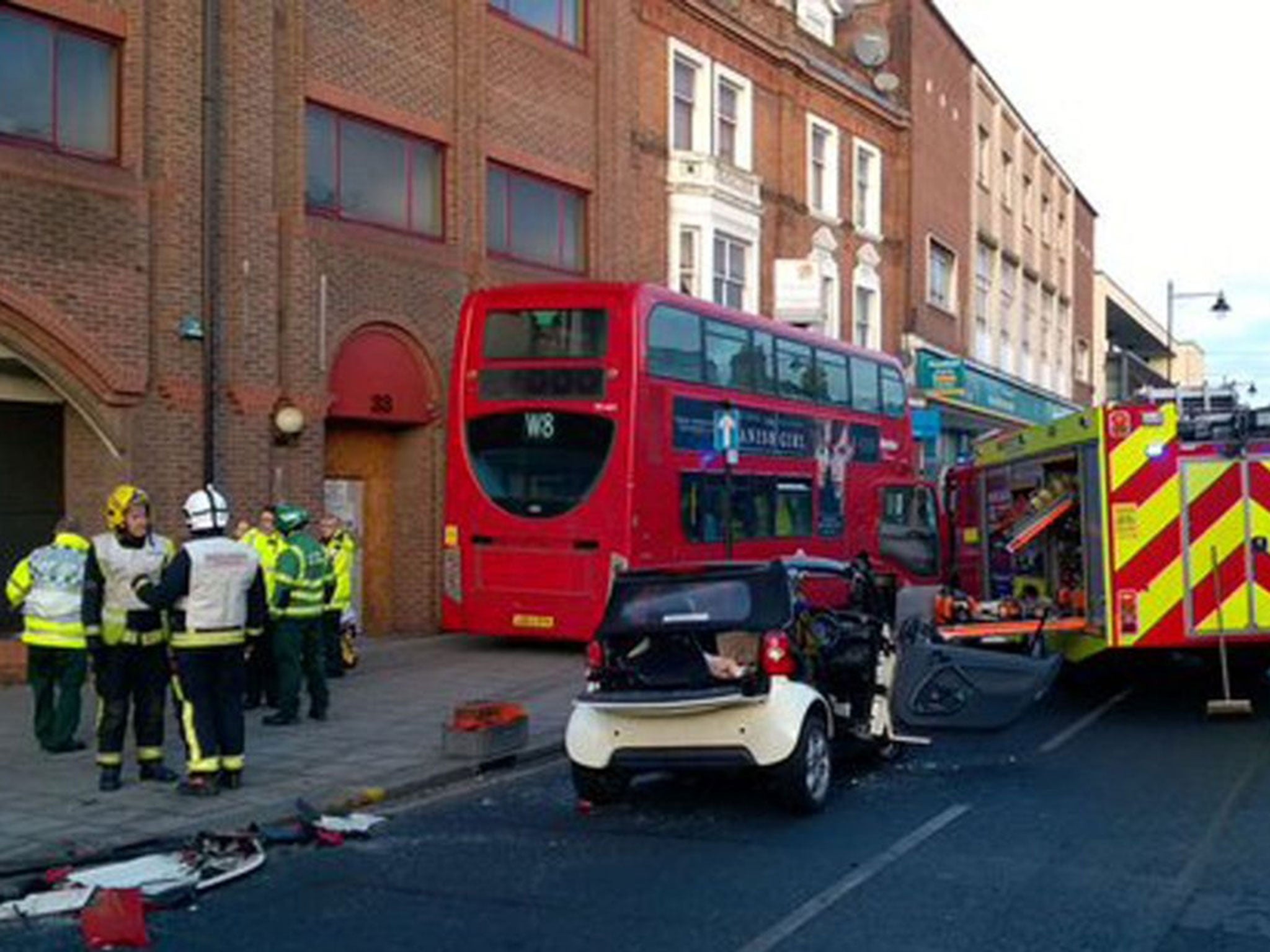 Emergency services attend a crash involving a smart car and a double-decker bus which mounted a kerb in London Road, Enfield