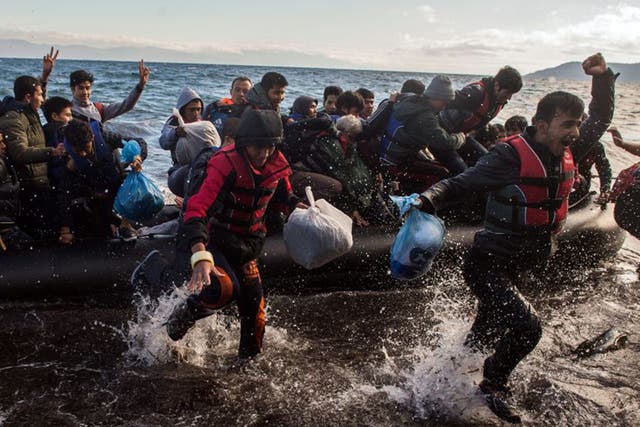 Asylum-seekers and migrants express relief as they go ashore  at Lesbos
