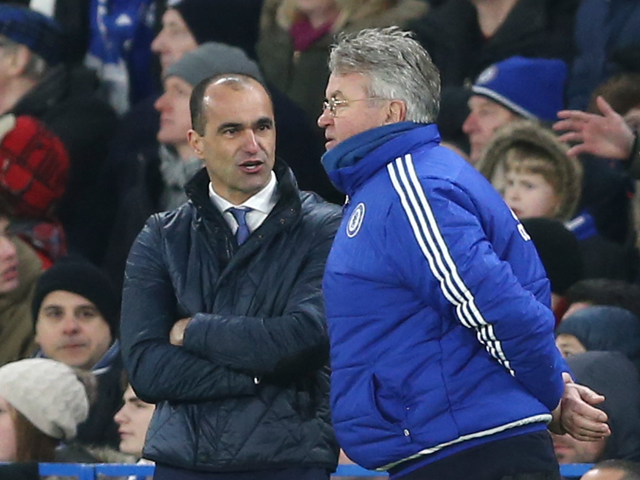 Everton manager Roberto Martinez talks with Guus Hiddink on the touchline