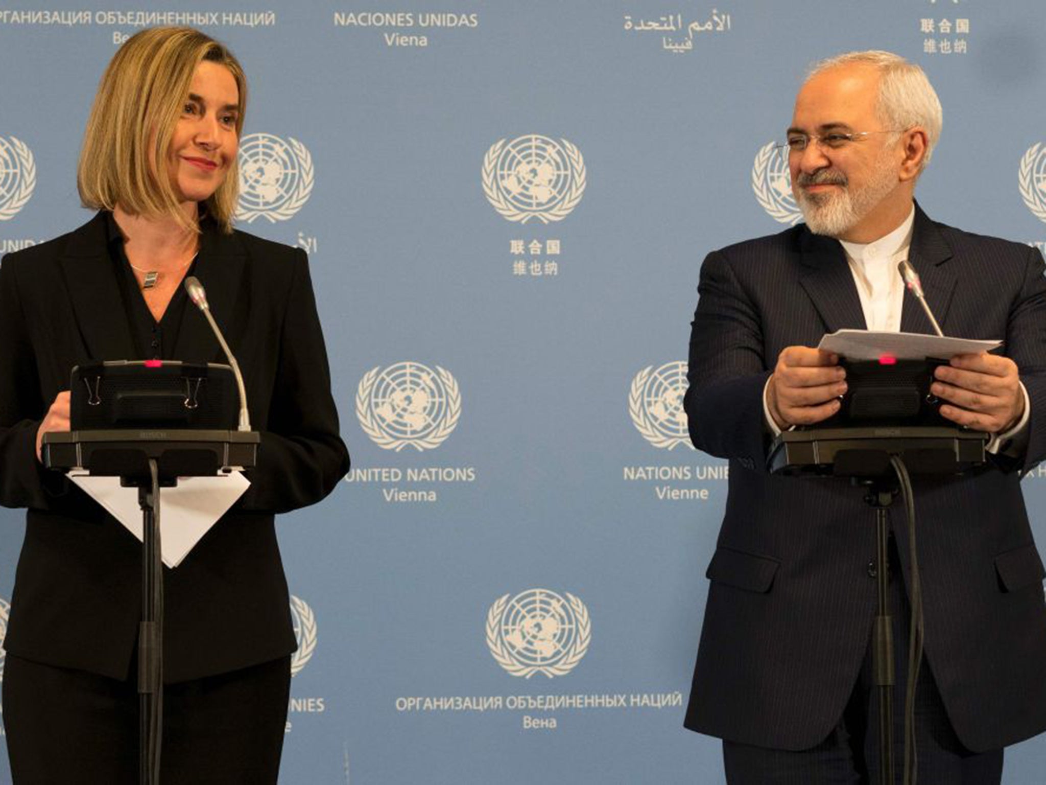 Iranian Foreign Minister Mohammad Javad Zarif, right, and EU foreign policy chief Federica Mogherini hold a joint press conference to make the announcement