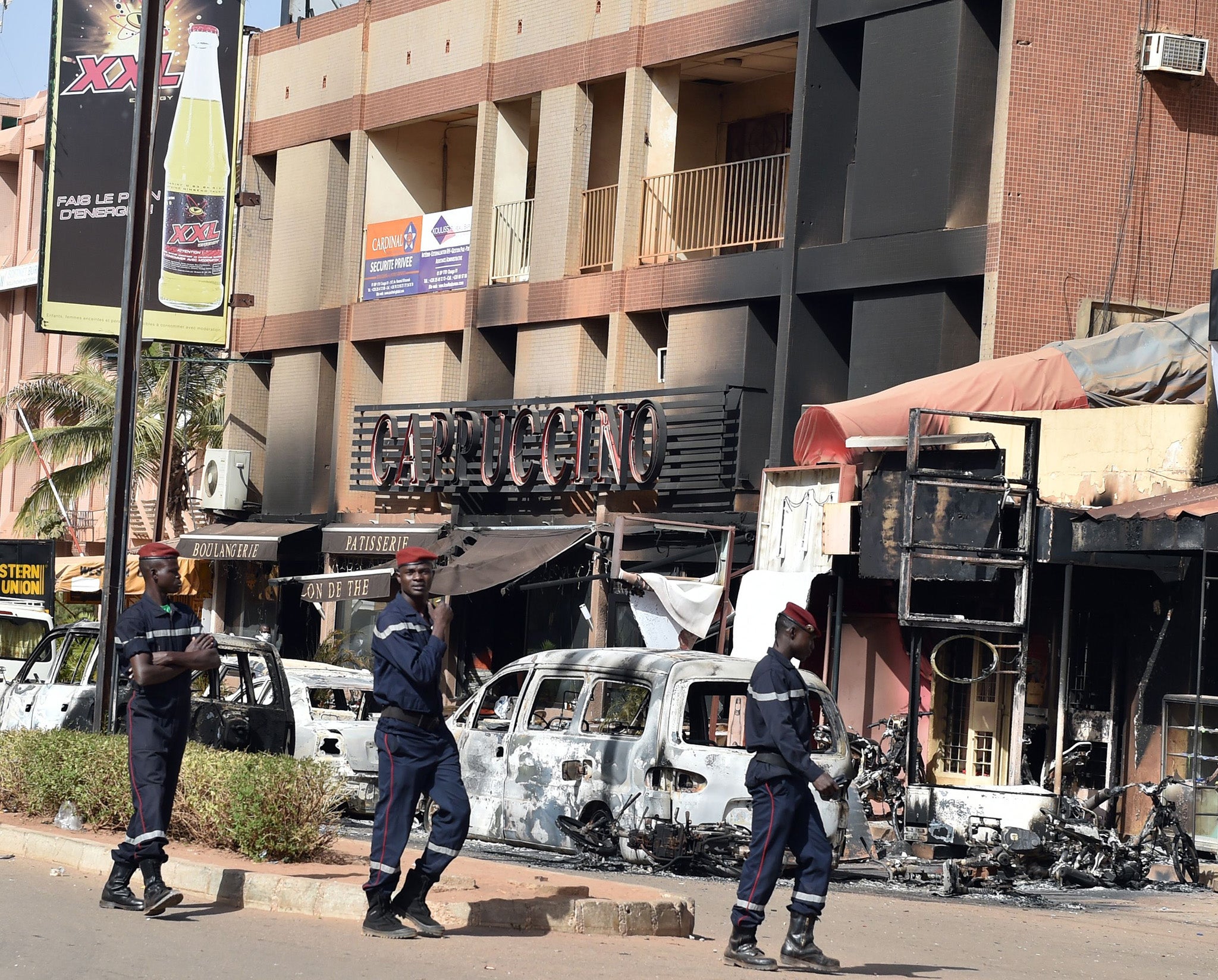 The soldiers patrol outside the Cappuccino Cafe in Ouagadougou, Burkina Faso in the aftermath of a terror assault on it and a nearby hotel