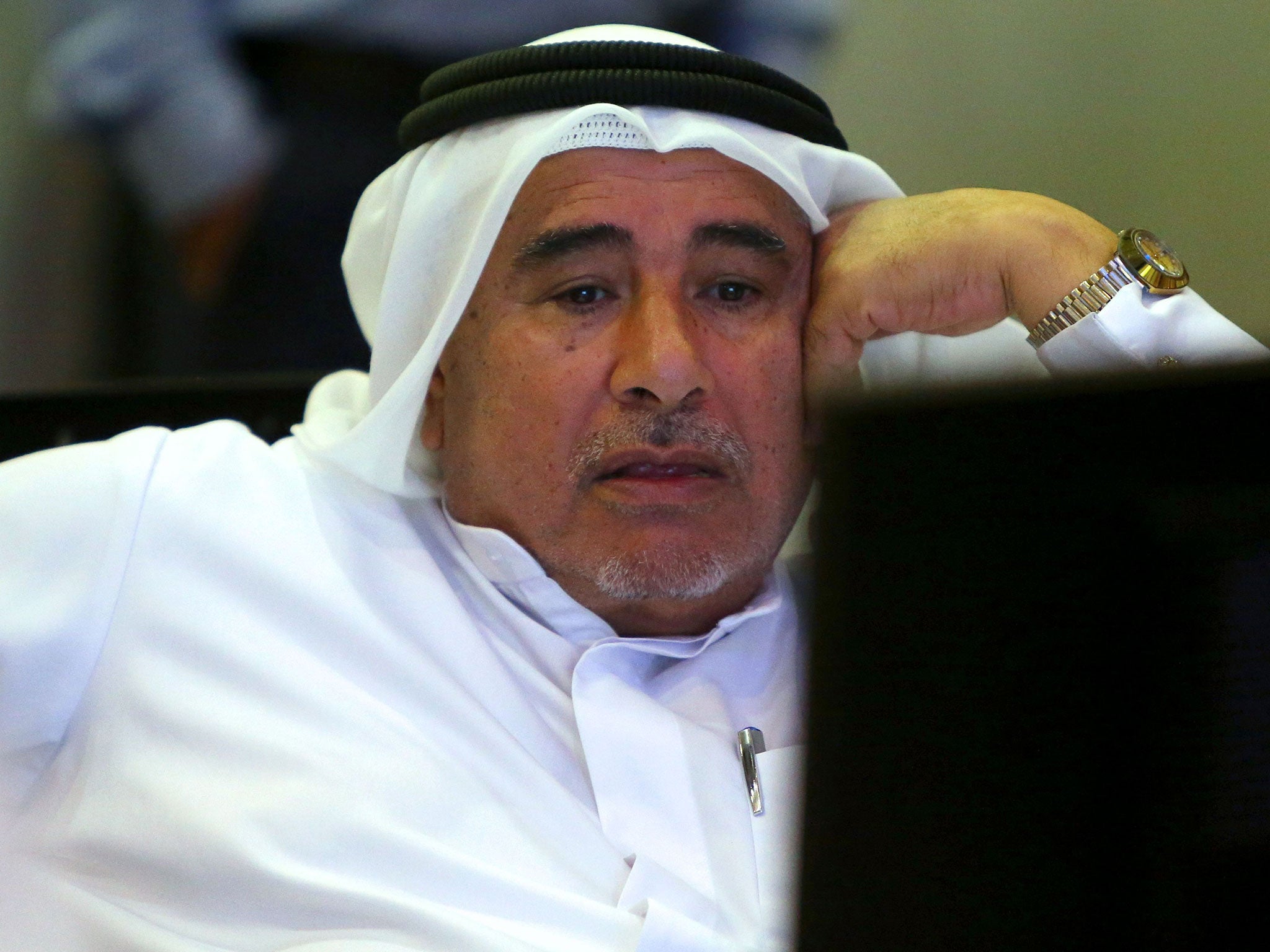 A trader in Dubai, where stocks fell 4.6 per cent, follows the slump on his computer screen