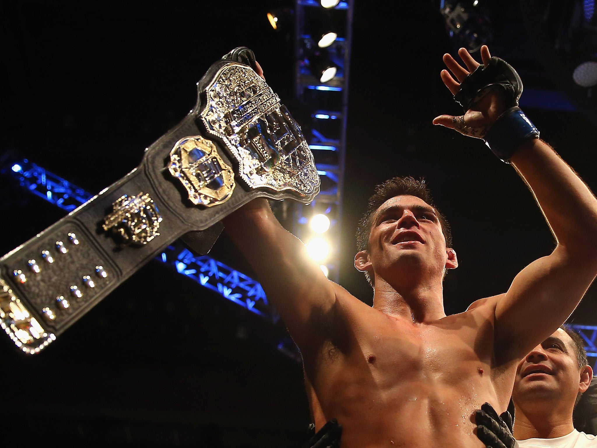 Dominick Cruz celebrates winning the UFC bantamweight title after beating TJ Dillashaw