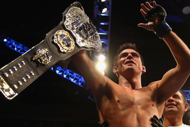 Dominick Cruz celebrates winning the UFC bantamweight title after beating TJ Dillashaw