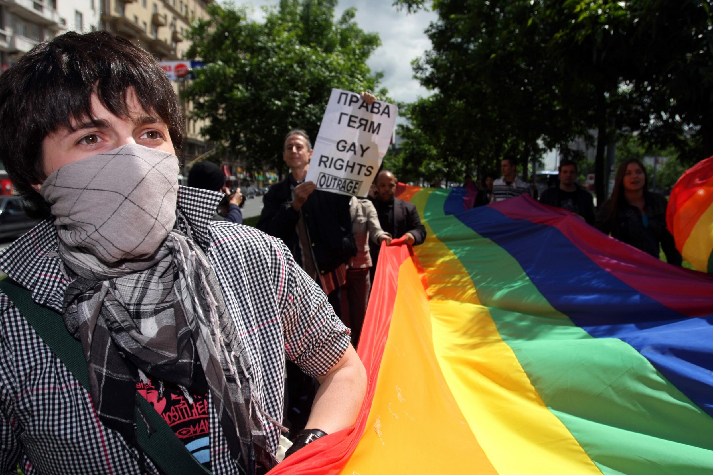 Members of the Russian gay community and gay rights activists from Europe hold flags during a banned gay rally in Moscow