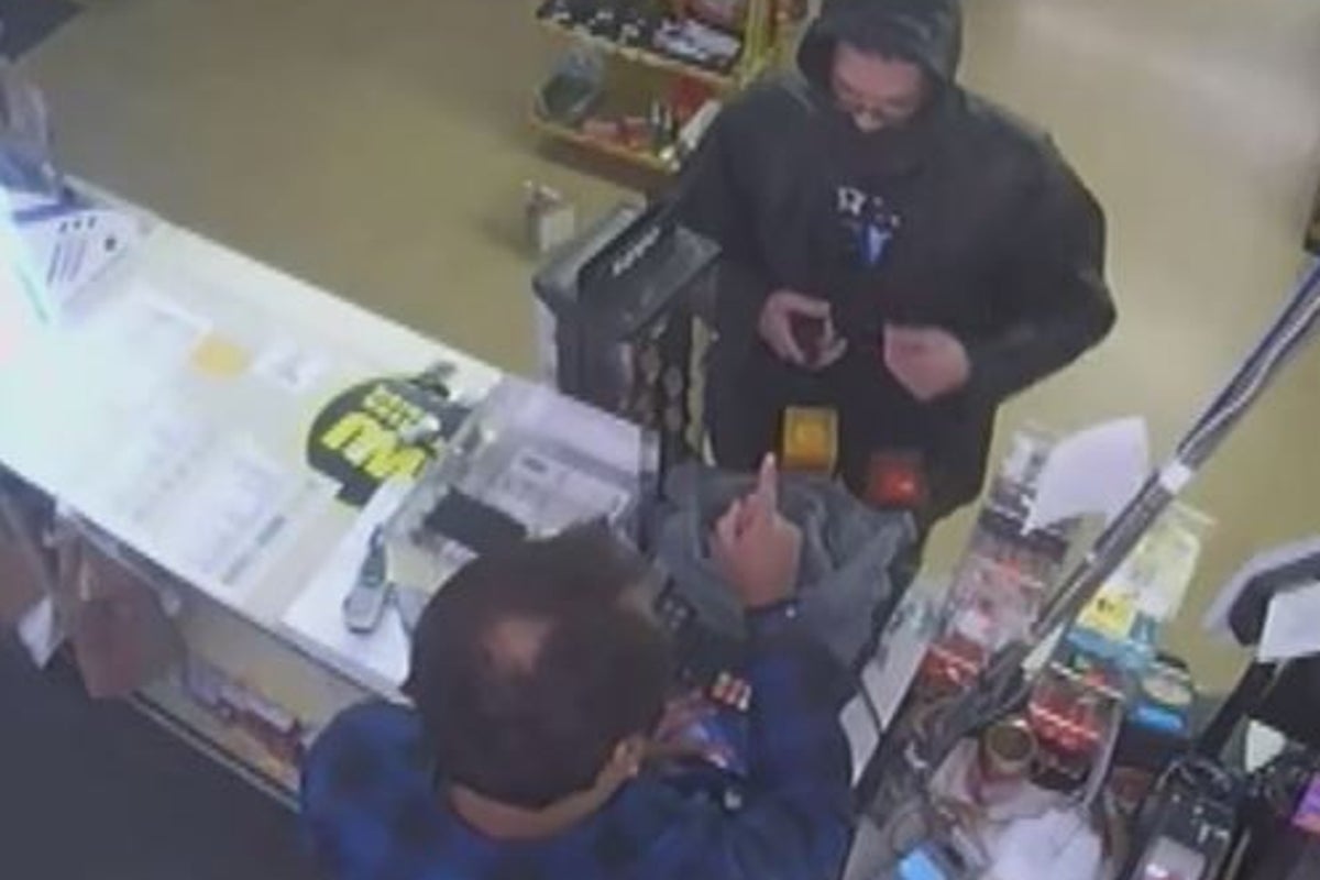 CCTV shows store owner scolding armed robber in shop stand-off | The ...