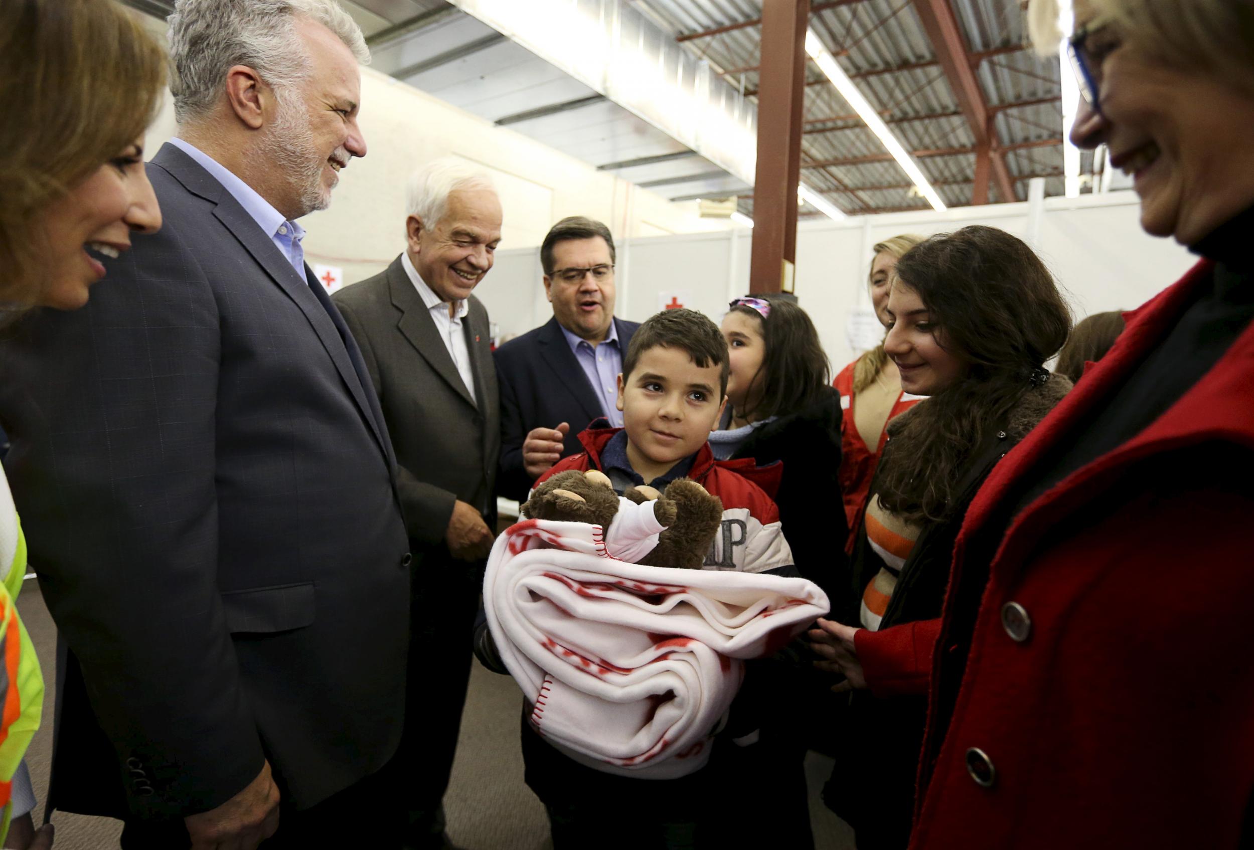 Canada's Immigration Minister John McCallum welcoming Syrian refugees at the Welcome Centre in Montreal, Quebec