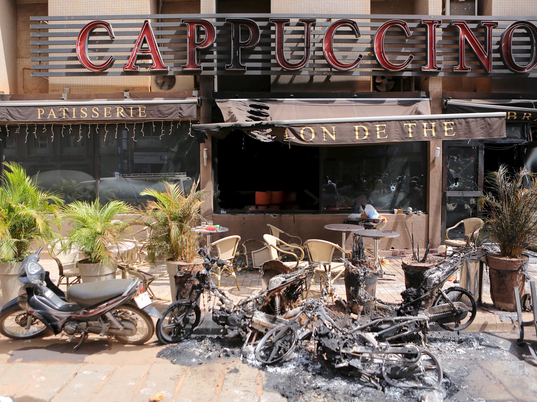 The burned-out exterior of "Cappuccino" restaurant is seen in Ouagadougou, Burkina Faso
