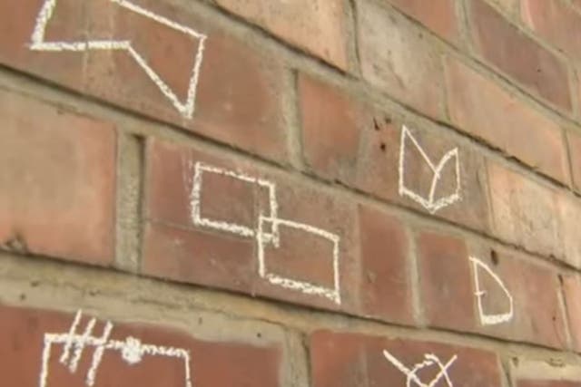The symbols, that have been spotted on roads, kerbs and walls, are said to be a criminal code