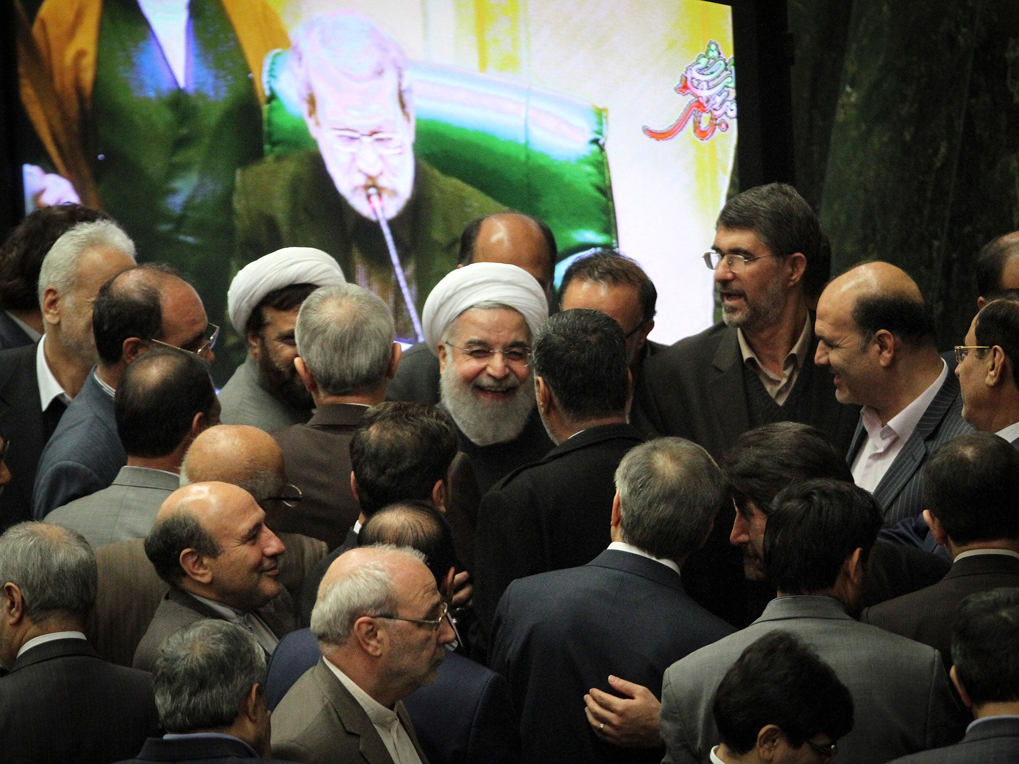 Iranian President Hassan Rouhani, centre, is eager to reduce the country's reliance on oil revenues