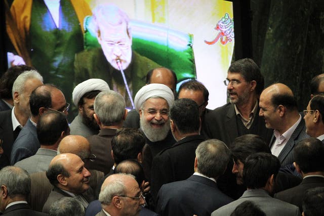 Iranian President Hassan Rouhani, centre, is eager to reduce the country's reliance on oil revenues