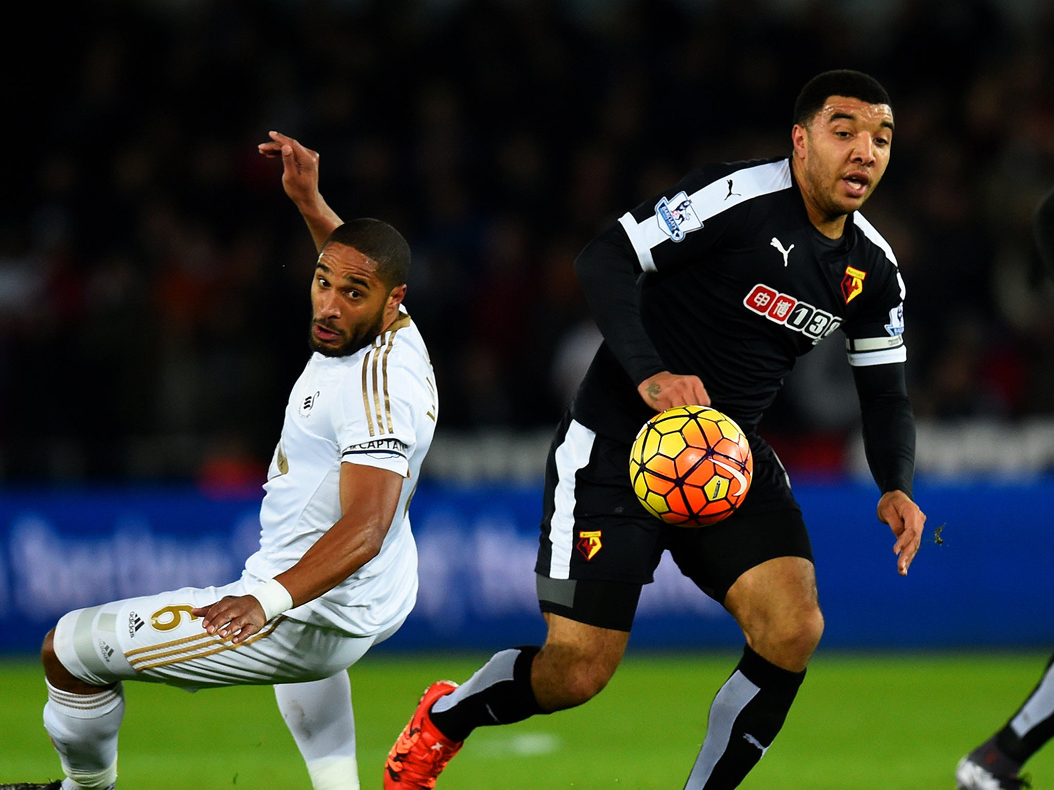 Troy Deeney escapes Ashley Williams at the Liberty Stadium