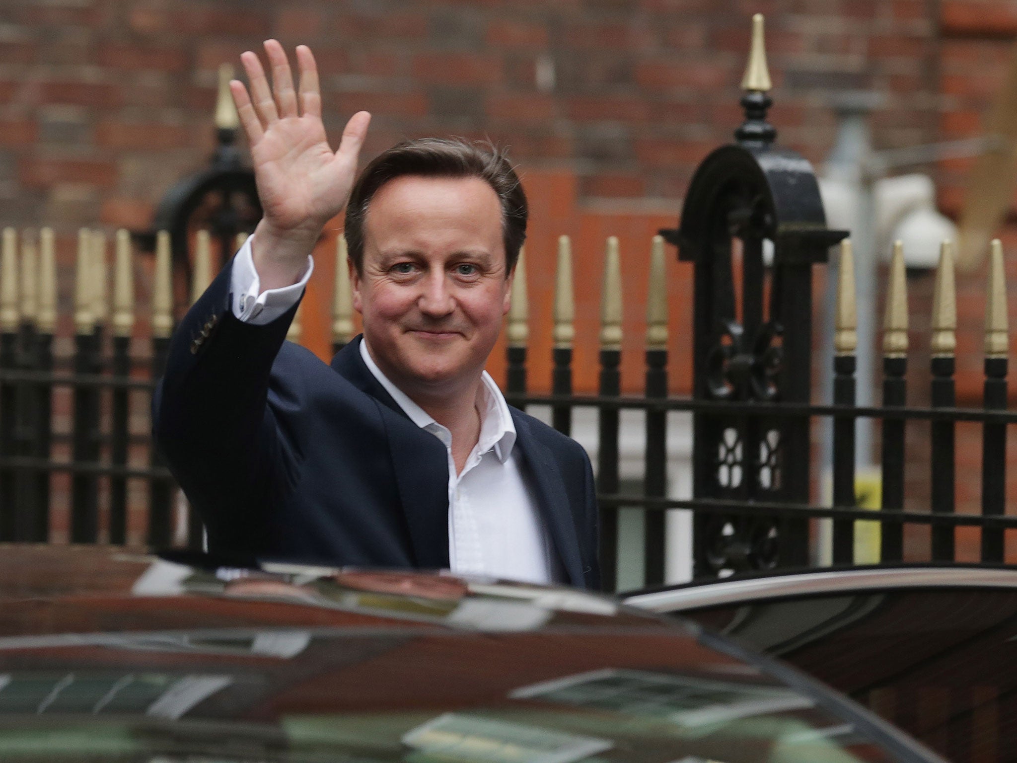 David Cameron leaves Conservative HQ after celebrating with party staff on the eve of his re-election