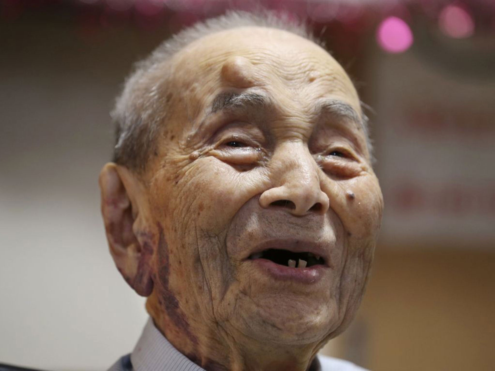 Yasutaro Koide being formally recognized as the world's oldest man by the Guinness World Records at a nursing home in Nagoya, central Japan, in August 2015.