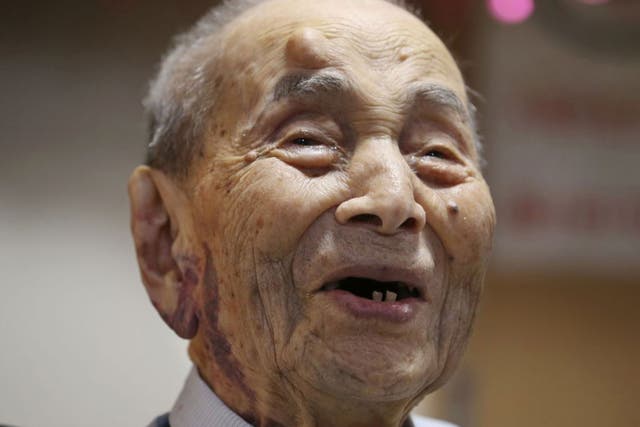 Yasutaro Koide being formally recognized as the world's oldest man by the Guinness World Records at a nursing home in Nagoya, central Japan, in August 2015.