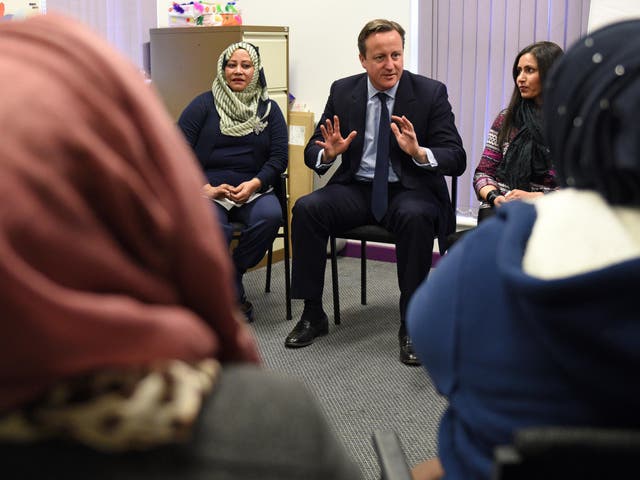 David Cameron speaks with women attending an English language class during a visit to the Shantona Women's Centre in Leeds