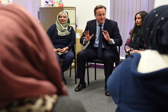 David Cameron speaks with women attending an English language class during a visit to the Shantona Women's Centre in Leeds
