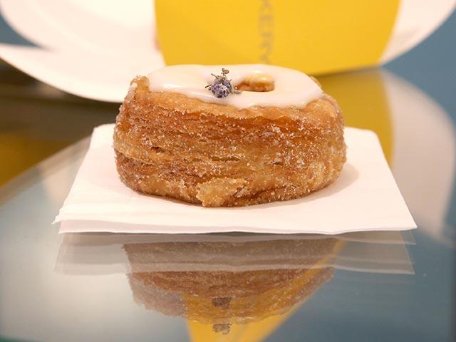 The Cronut is rolled in sugar, filled with cream and topped with glaze