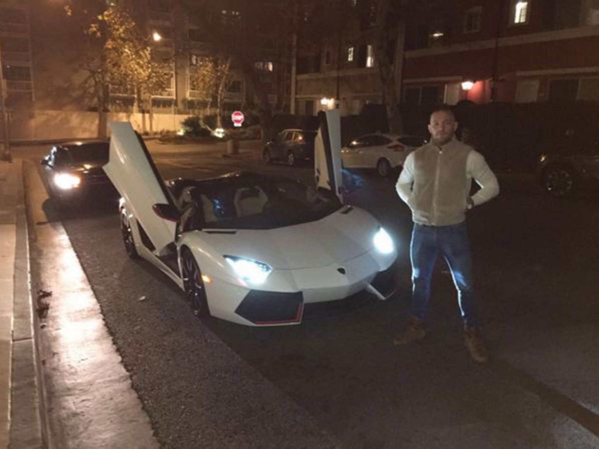 Conor McGregor poses next to his new £280,000 Lamborghini Aventador