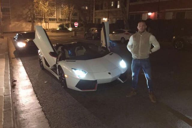 Conor McGregor poses next to his new £280,000 Lamborghini Aventador