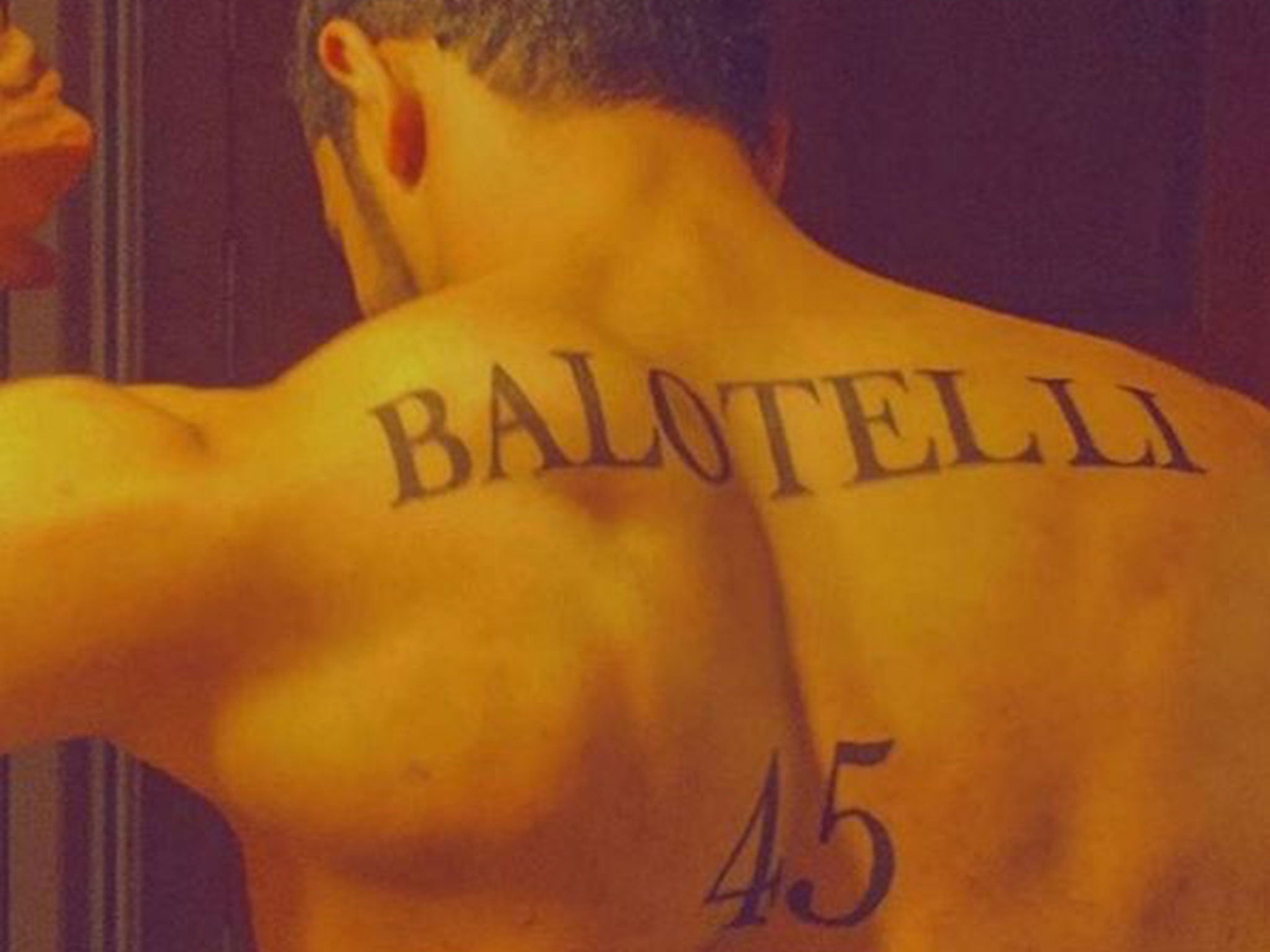 A football fan has had Mario Balotelli's surname tattooed onto his back