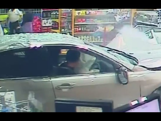 Video shows woman narrowly escape death after car smashes into service station