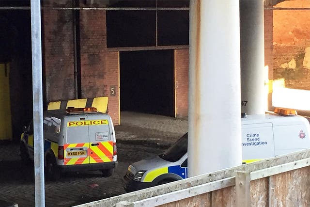 Police cars close to the scene underneath a railway bridge in Salford, Greater Manchester