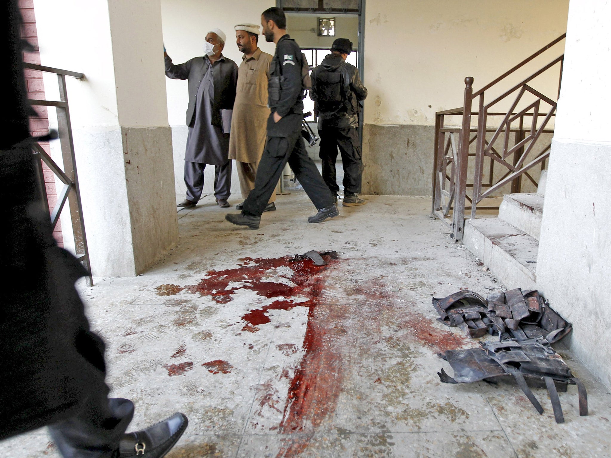 Blood stains and flak jackets used by attackers remain in the hallway of a dormitory where the attack took place