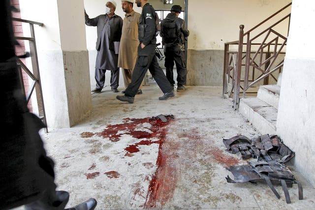 Blood stains and flak jackets used by attackers remain in the hallway of a dormitory where the attack took place