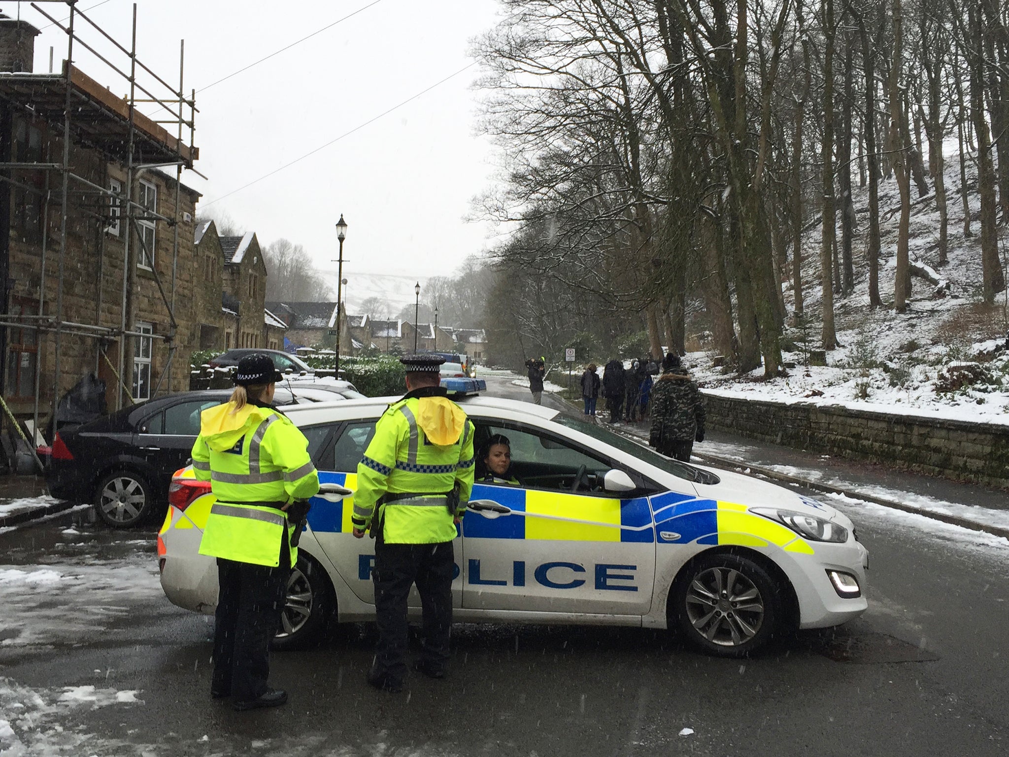 Police near the scene after mother-of-three Sadie Hartley, 60, was murdered in a "ferocious" knife attack at her home in Helmshore