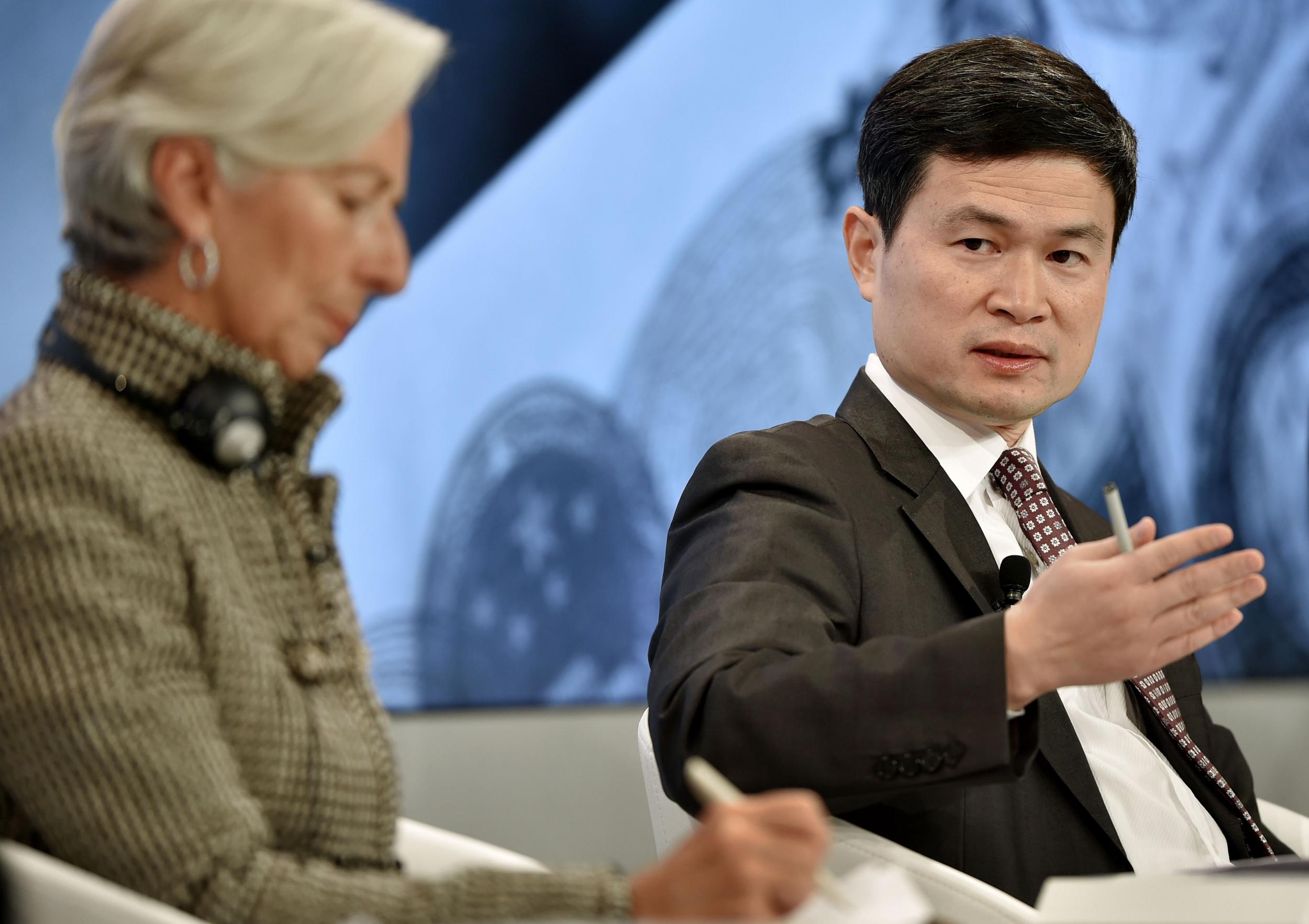 Chinese Central Leading Group for Financial and Economic's Fang Xinghai (R) gestures next to International Monetary Fund (IMF) Managing Director Christine Lagarde during a session at the World Economic Forum (WEF) annual meeting in Davos, on January 21, 2016.