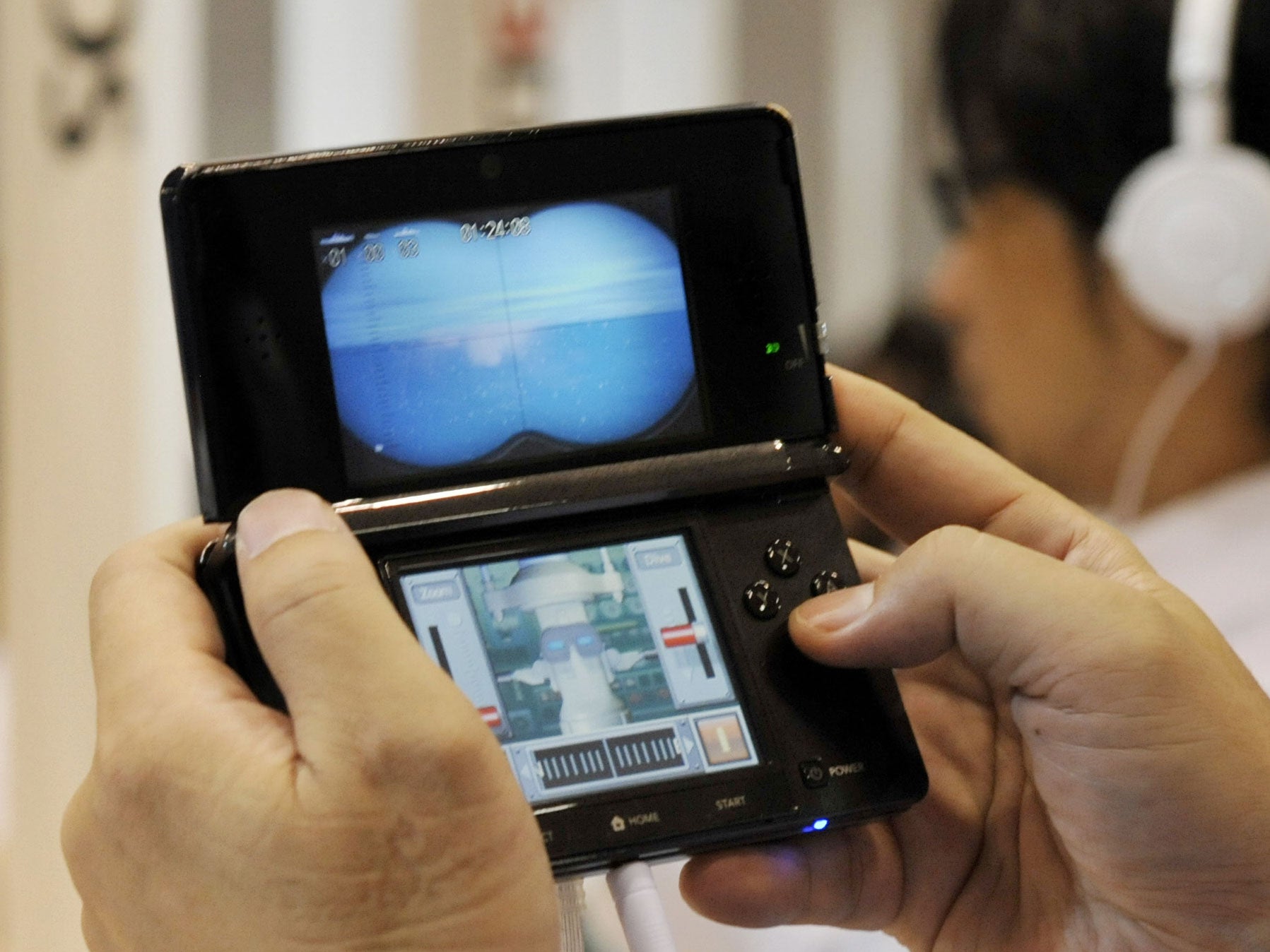 A man plays on a Nintendo 3DS at an event in Tokyo