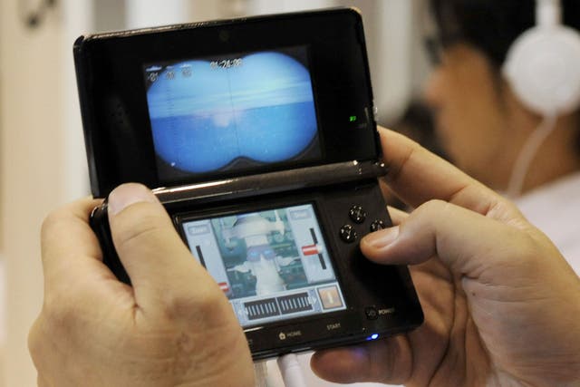 A man plays on a Nintendo 3DS at an event in Tokyo