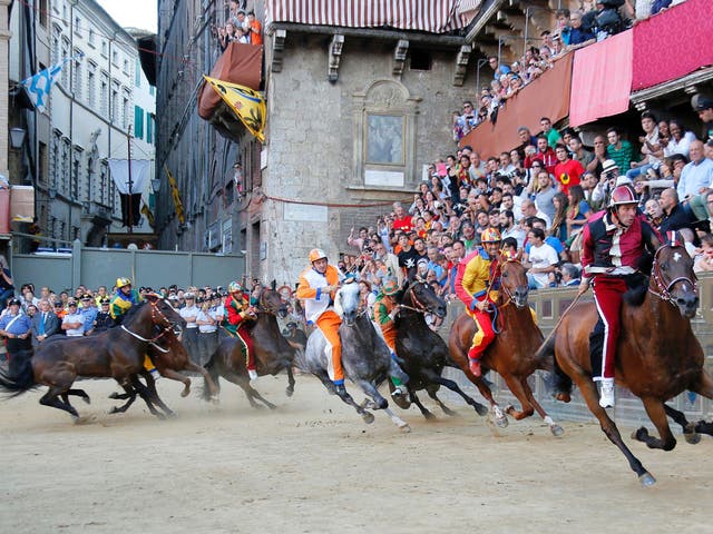 The traditional Palio race takes place in July and August in the medieval town square of Siena