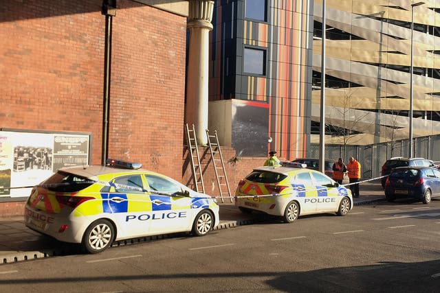 Police close to the scene in Salford, Greater Manchester, after a man's body was discovered next to a burning tent