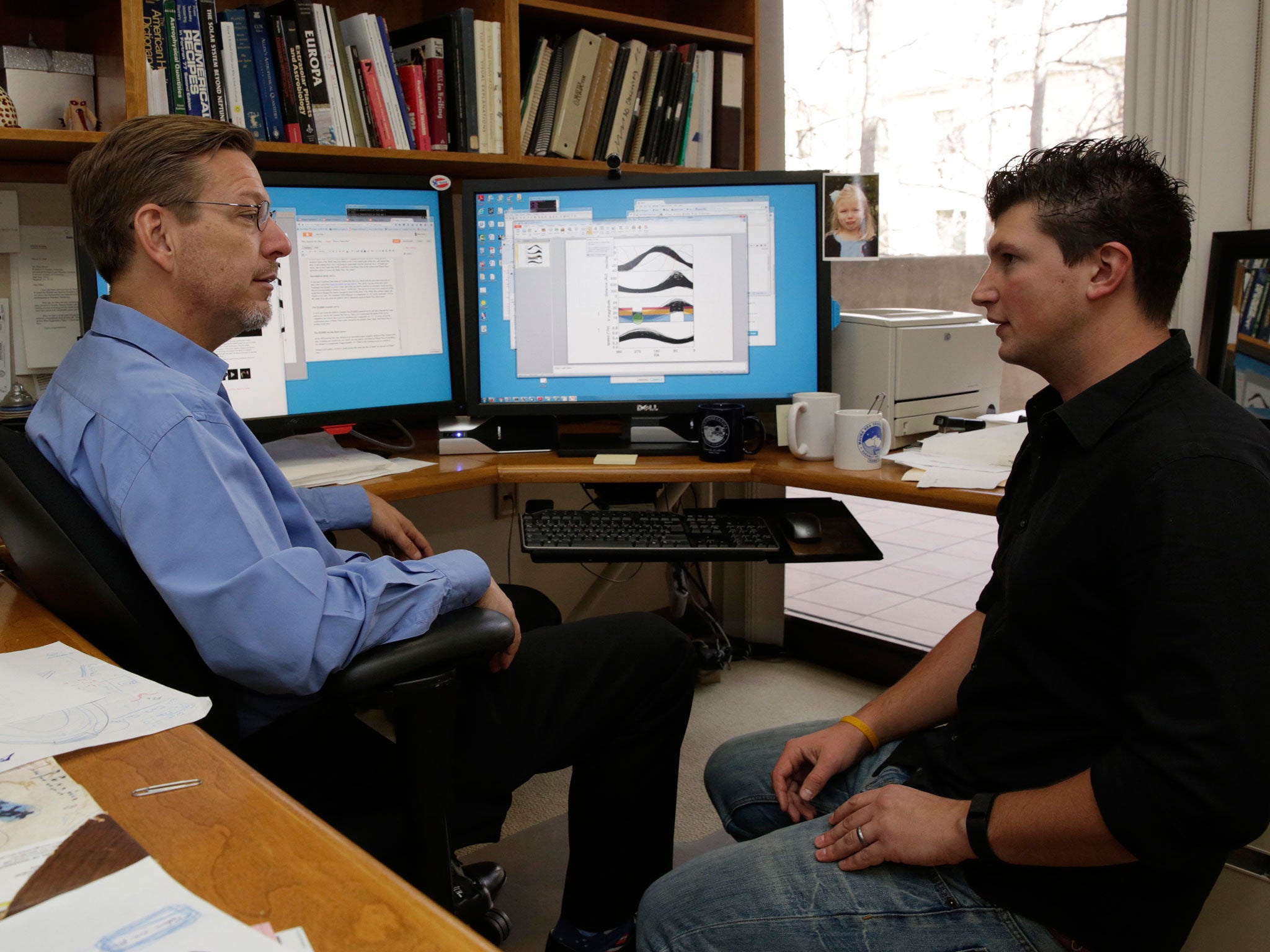 California Institute of Technology scientists, Michael Brown, left, and Konstantin Batygin, Assistant Professor of Planetary Science review their research in Pasadena, California. The scientists reported that they have 'good evidence' for Planet 9, a true ninth planet on the fringes of our solar system
