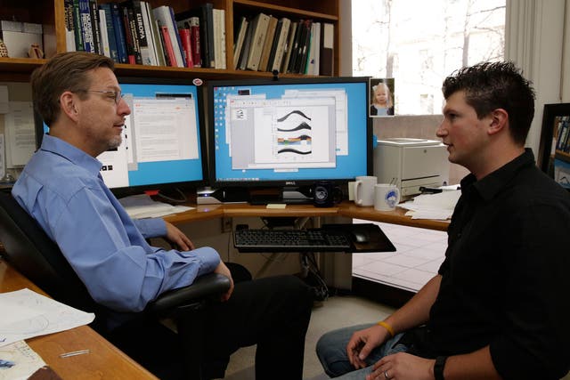 California Institute of Technology scientists, Michael Brown, left, and Konstantin Batygin, Assistant Professor of Planetary Science review their research in Pasadena, California. The scientists reported that they have 'good evidence' for Planet 9, a true ninth planet on the fringes of our solar system