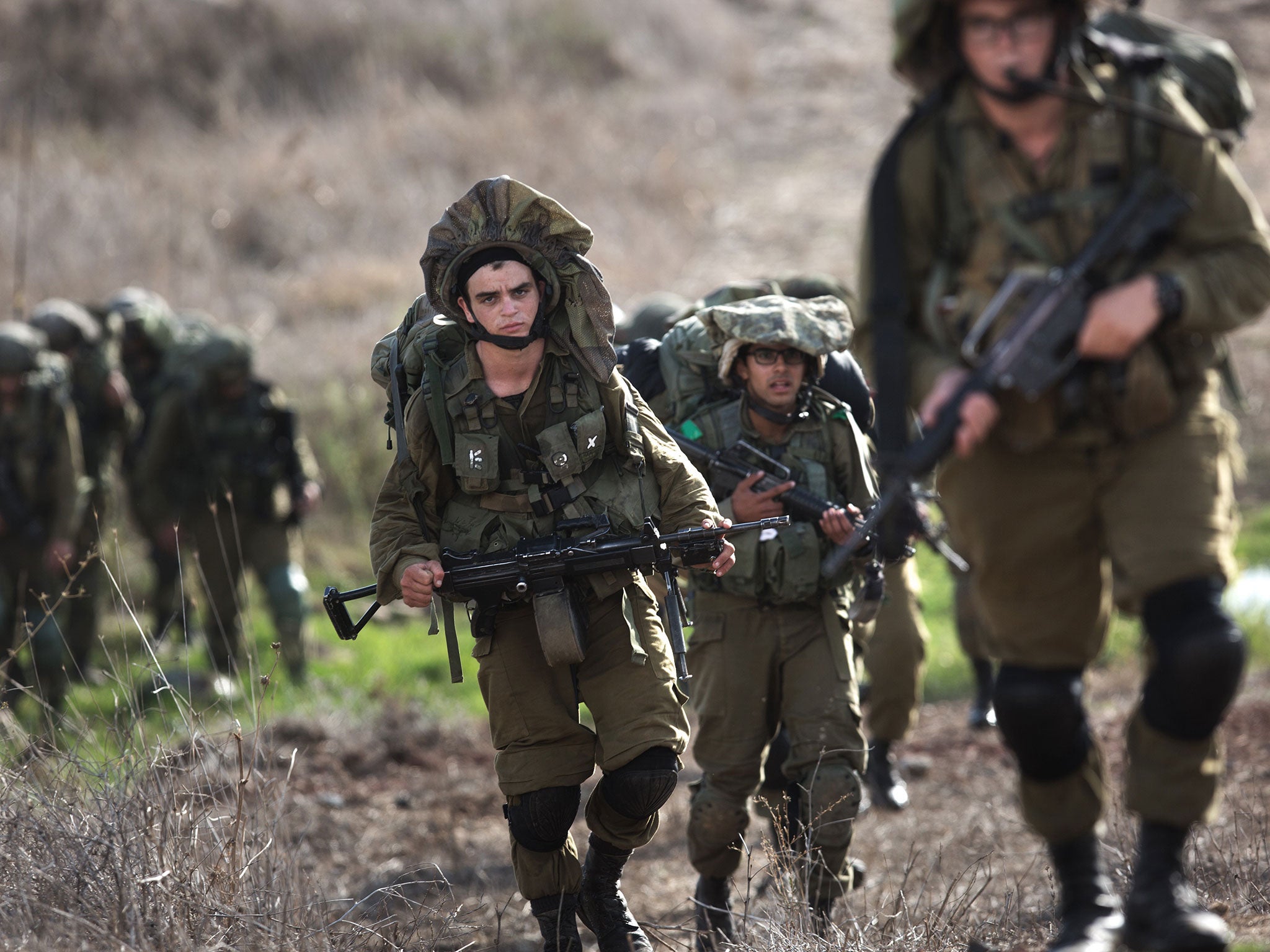 Israeli soldiers perform exercises in the Golan Heights. Stray rockets have occasionally – and apparently accidentally – struck across the border since the Syrian war began