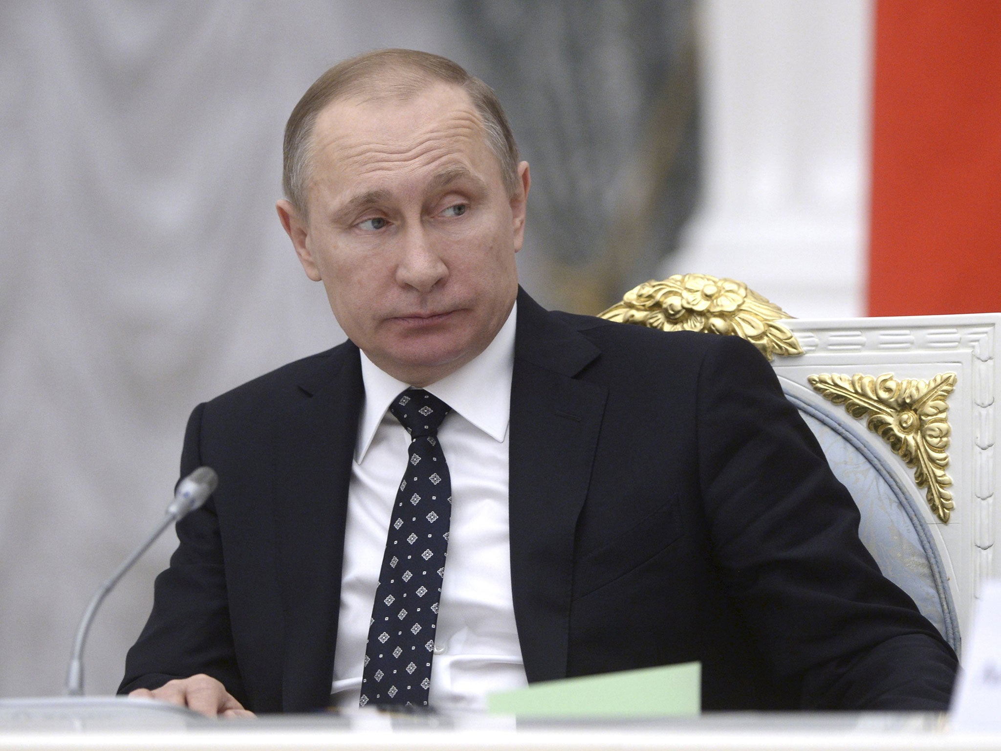 Vladimir Putin, chairing a meeting at the Kremlin last week, faces accusations of corruption
