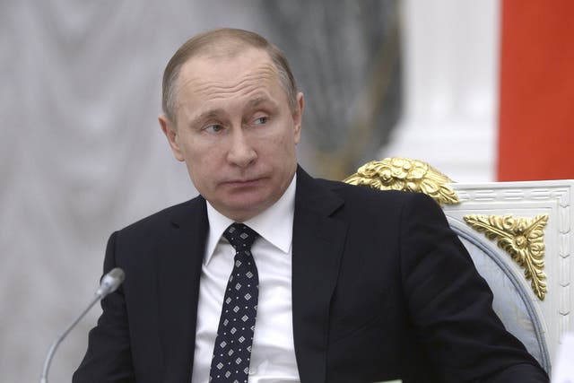 The Russian President, Vladimir Putin, chairing a Kremlin meeting yesterday, was directly implicated by the inquiry in the death of the former spy