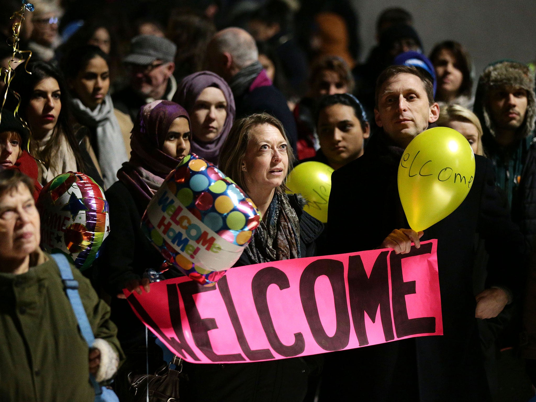 Supporters and well-wishers at St. Pancras International station in London wait to greet the arrival of four Syrian refugees