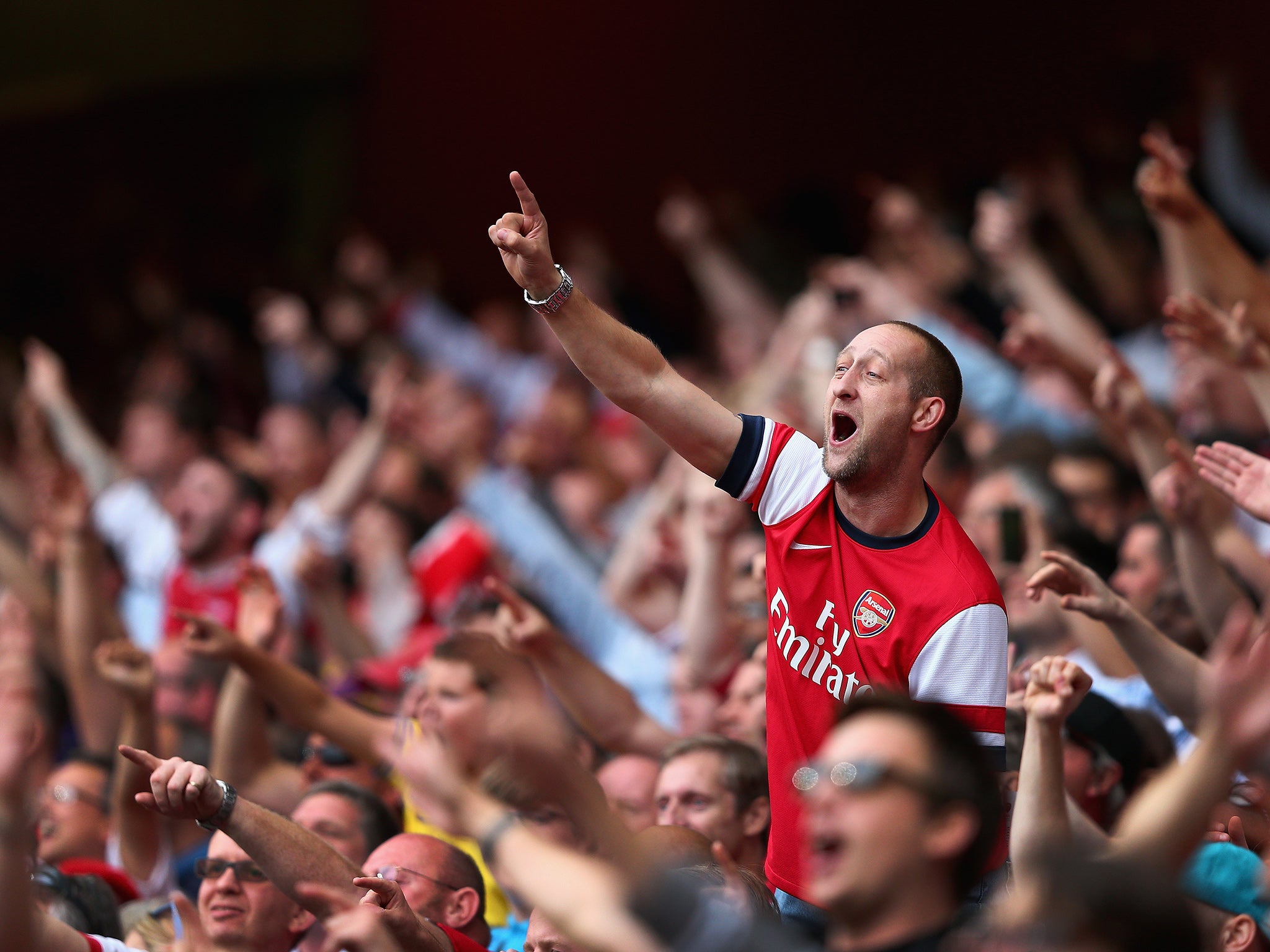 Arsenal supporters celebrate following a victory at the Emirates