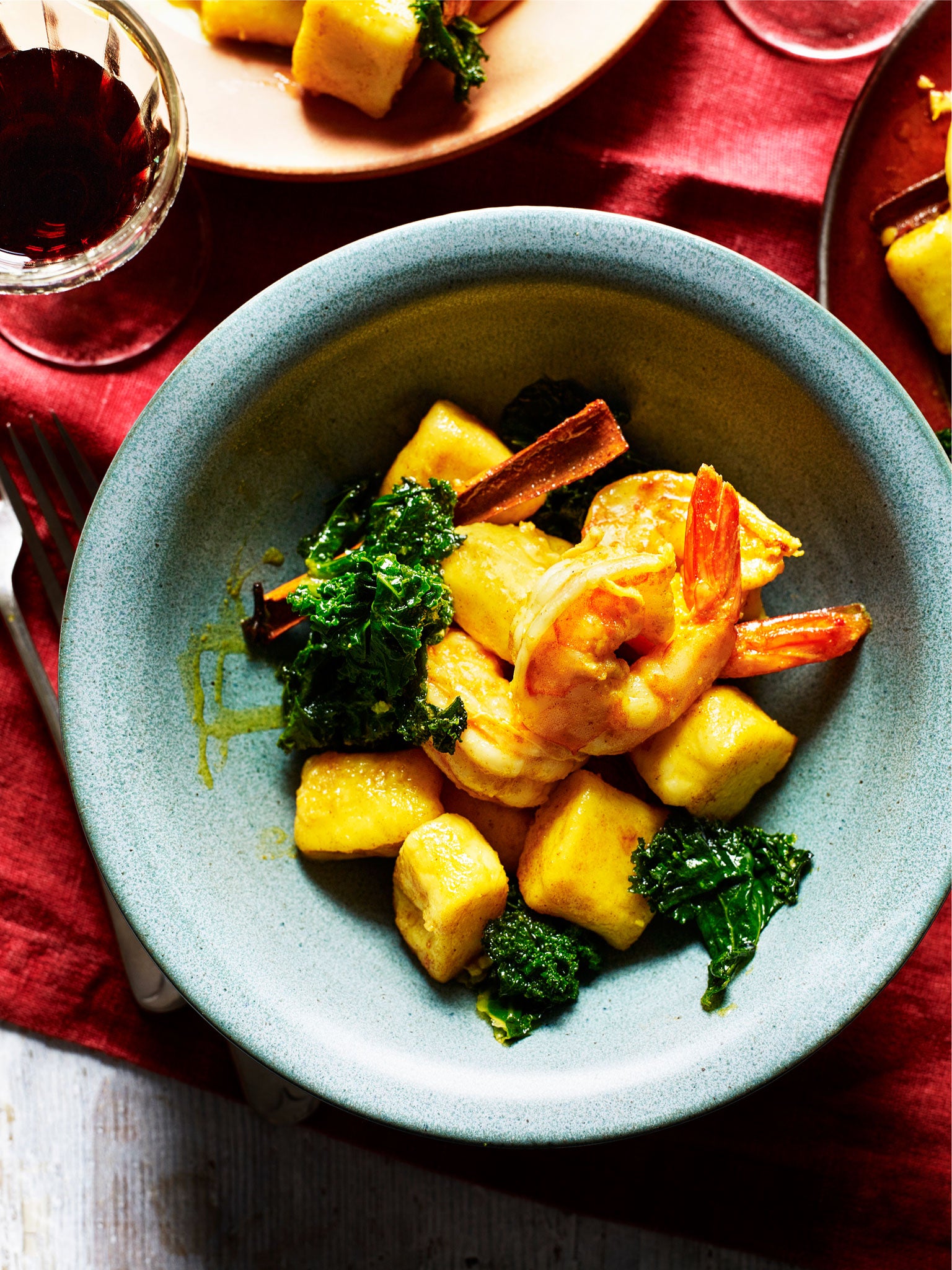 Home-made gnocchi with prawns, spices and winter kale