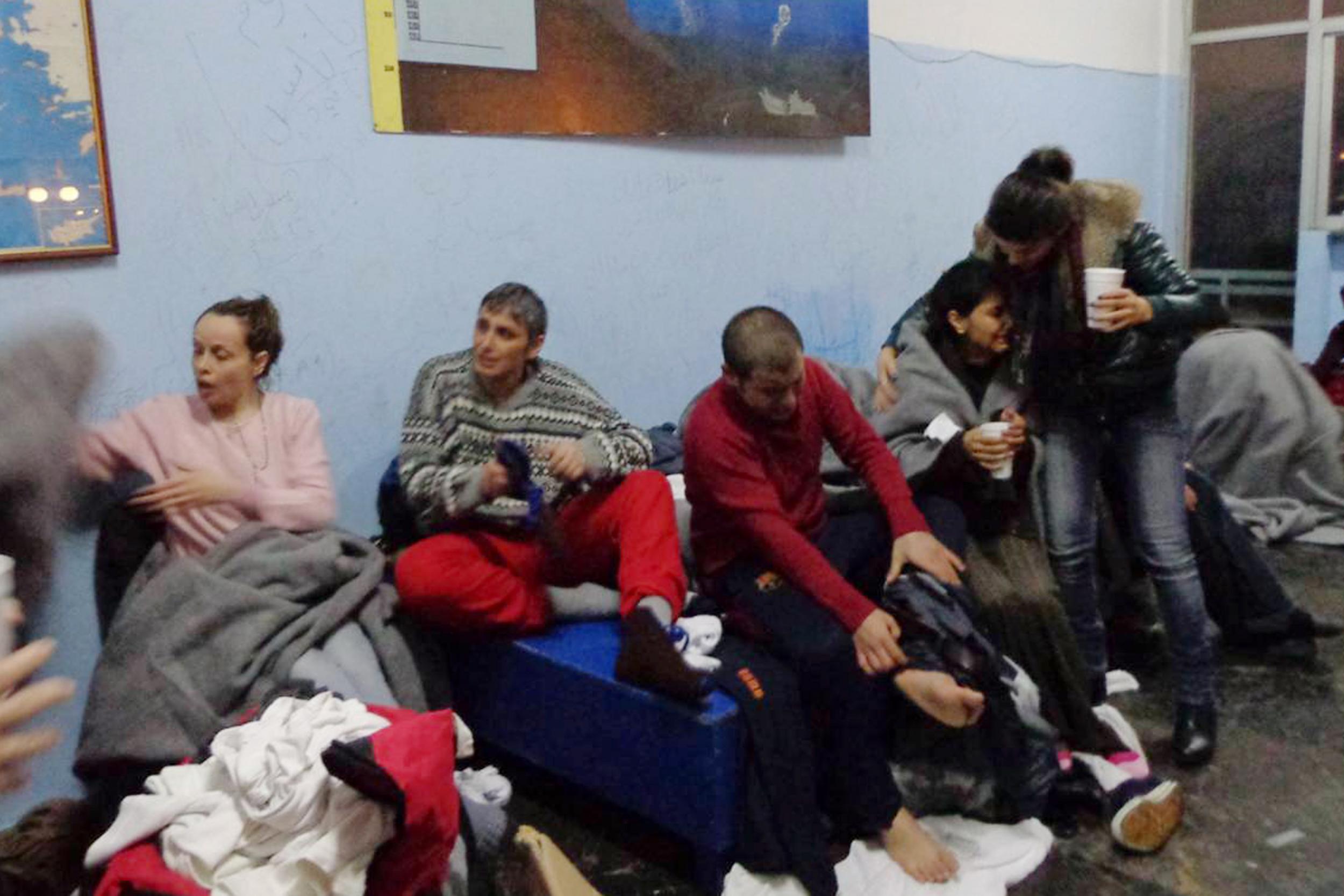 Migrants recovering after being rescued by the Greek Coastguard