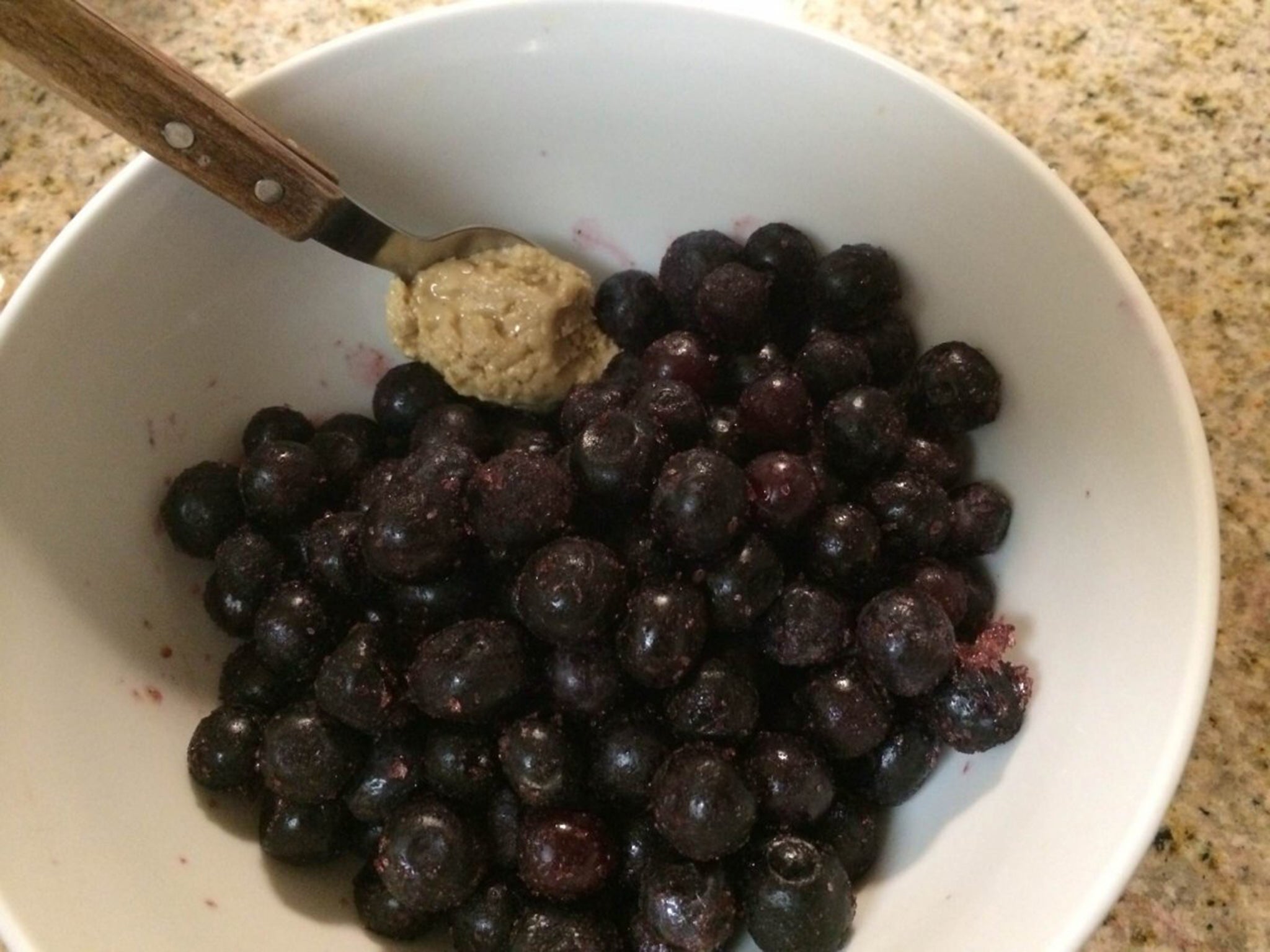 Frozen blueberries with a spoonful of cashew butter.