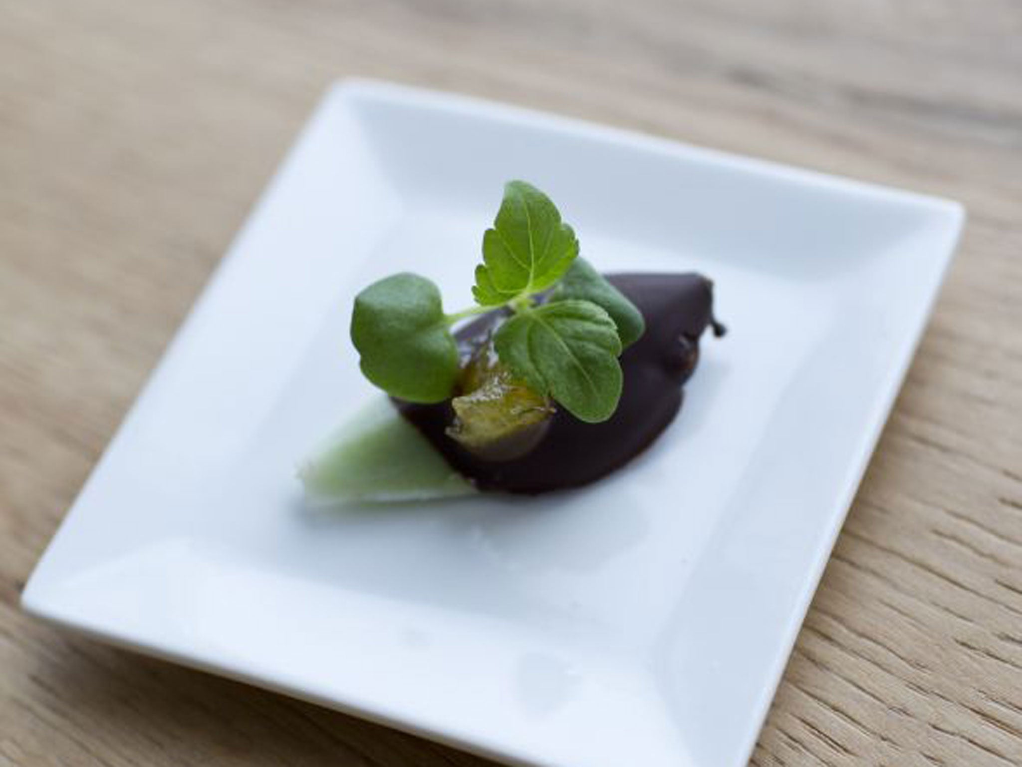 Citrus-flavoured Majii Leaf dipped in dark chocolate, served with orange compote and Ghoa Cress (Tom Moggach)