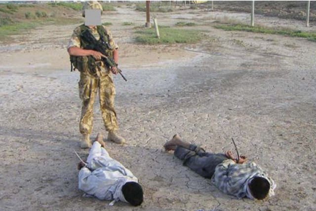 Detained Iraqis being guarded by a British soldier that was shown at the The Al-Sweady Inquiry. The long-running inquiry into claims that British troops killed and tortured Iraqi civilians a decade ago will deliver its final report